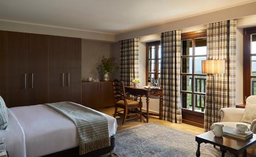 a bedroom with a bed and a desk in a room at MounTrace Suites & SPA in Monodendri
