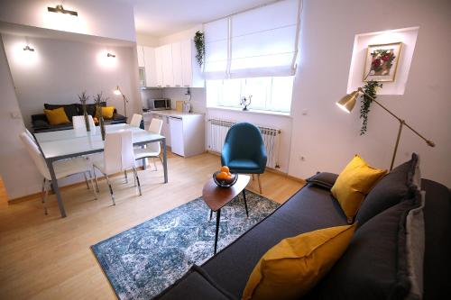 a living room with a couch and a table at La Vie Est Belle in Zagreb