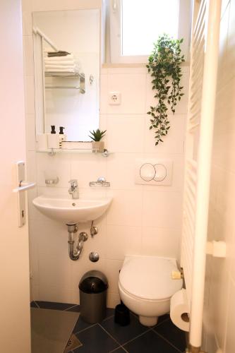 a small bathroom with a toilet and a sink at La Vie Est Belle in Zagreb