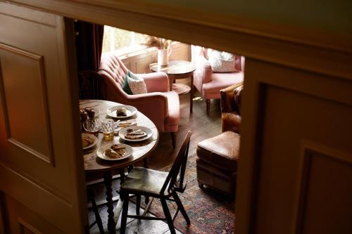 a living room with a table and chairs at The Pembroke Arms in Salisbury