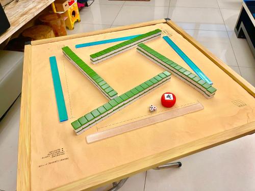 a wooden table with a game of billiards on it at 安平72號民宿 in Tainan