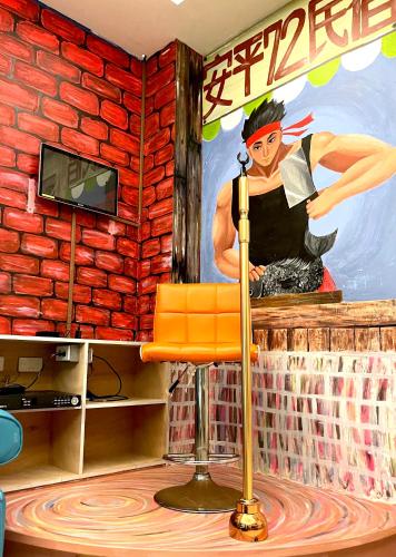 a room with a bar with a painting on the wall at 安平72號民宿 in Tainan