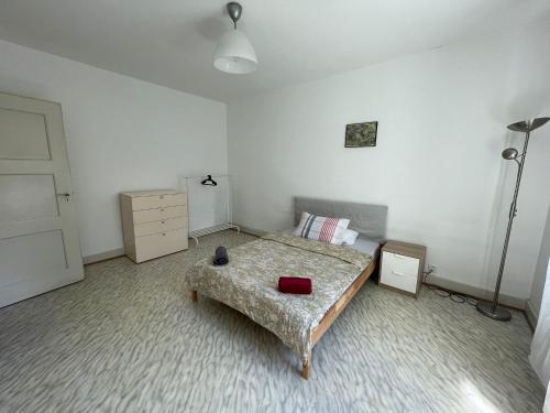 a bedroom with a bed and a lamp in it at Heart of Basel, Beautiful Guest House in Basel