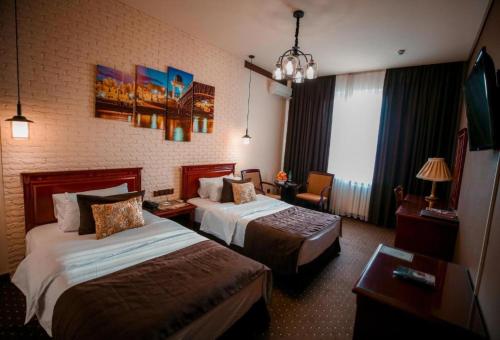 Postel nebo postele na pokoji v ubytování Asia Tashkent Hotel