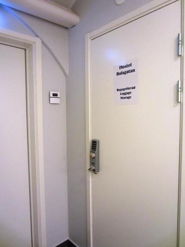 a room with a door with a sign on it at Hostel Dalagatan in Stockholm