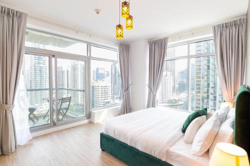 a bedroom with a large bed and large windows at Full Marina View Luxury 2BR - Park Island Sanibel in Dubai