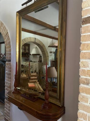 a mirror on a wall with two red candles at Villa sul Mare in Chalkida