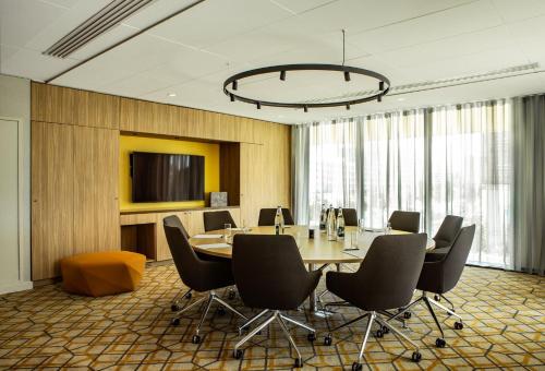a conference room with a table and chairs at Crowne Plaza - Nice - Grand Arenas by IHG in Nice