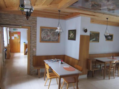 a dining room with tables and chairs in a restaurant at Waldpension Stachl in Bromberg