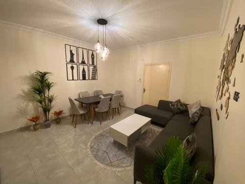 a living room with a couch and a table at Lovely 3-bedrooms rental unit in Aqaba