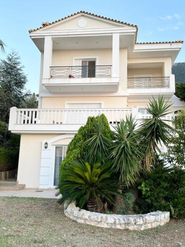 a white house with plants in front of it at Villa sul Mare in Chalkida