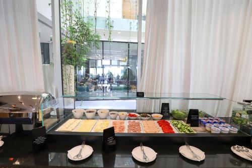 a buffet of food on a table in a building at Best Western Premier Ark Hotel in Tirana