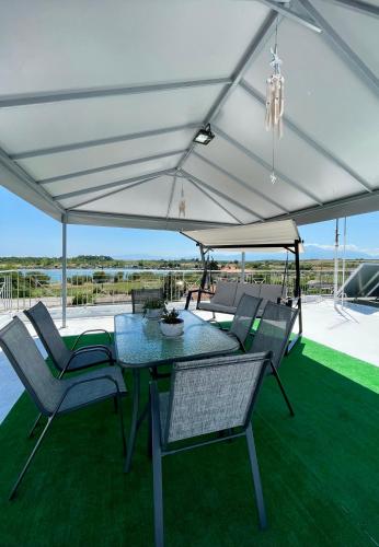 a table and chairs under a white tent at Hotel Medousa in Skála Alykís
