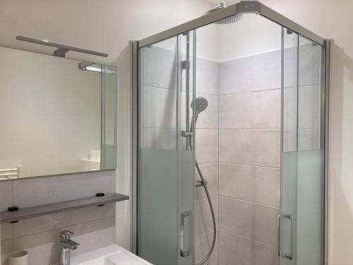 a shower with a glass door in a bathroom at La Maison du Cocher - Studio climatisé en Hypercentre in Angers