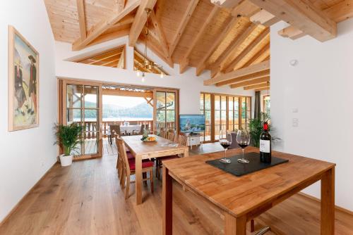 a dining room with a table with wine glasses on it at Villa Frischmuth am See in Altaussee