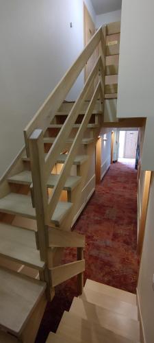 a staircase in a house with a wooden stair case at Hotel Kahlberg in Krynica Morska