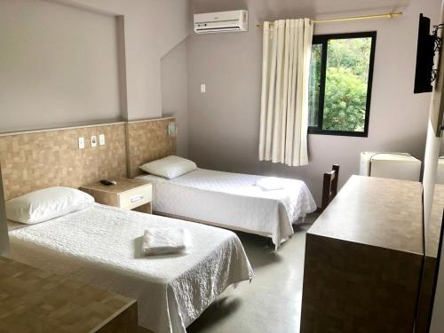 Un pat sau paturi într-o cameră la Hotel Rinkao
