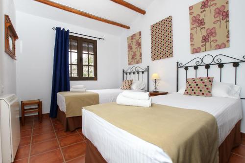 Postel nebo postele na pokoji v ubytování Casitas de la Sierra