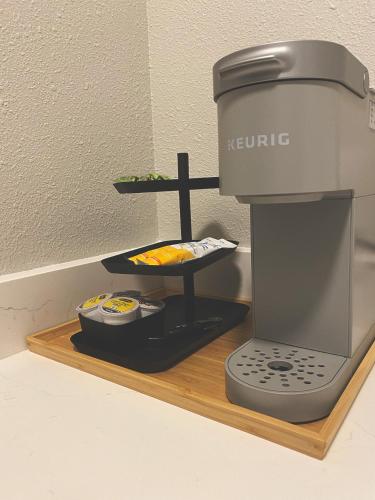 a coffee maker on a wooden tray with food at Winter Park Chateau in Winter Park