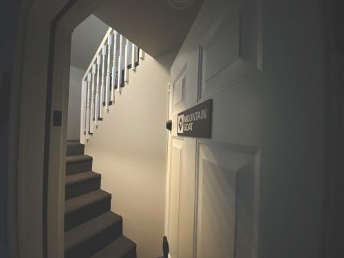 a hallway with stairs and a sign that reads midnight north at Winter Park Chateau in Winter Park