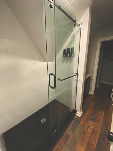 a glass shower in a room with a staircase at Winter Park Chateau in Winter Park