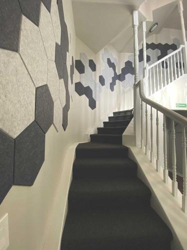 a hallway with stairs with a mural on the wall at Winter Park Chateau in Winter Park