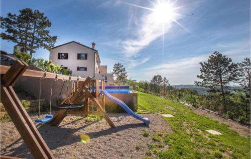 a swing set on a hill with the sun in the background at Amazing Home In Gracisce With Sauna in Gračišče