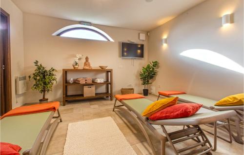 a room with chairs and tables and a window at Amazing Home In Gracisce With Sauna in Gračišče