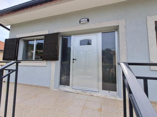 a white door on a house with windows at Apartamento Armães in Viana do Castelo
