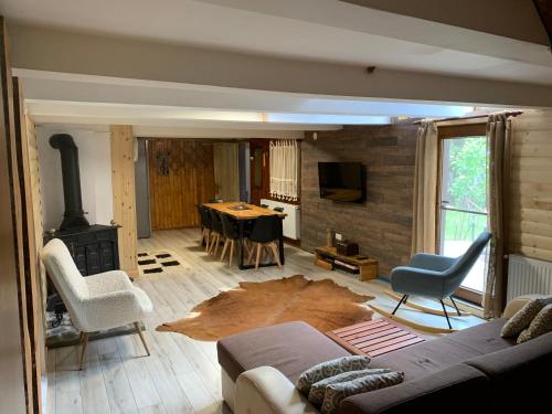 a living room with a couch and a fireplace at Lucomi Chalet - For groups - 5 bedrooms in Poiana Ţapului