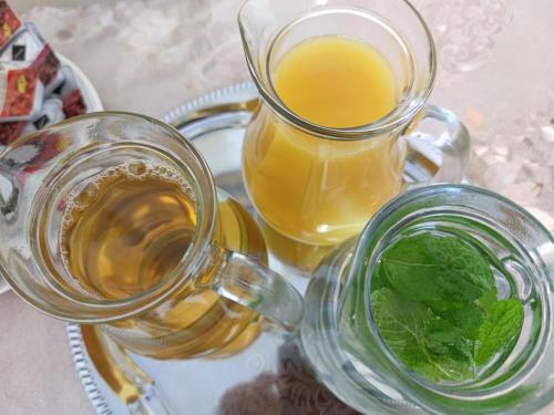 two glasses of tea and a jug of orange juice at Hotel Dejmalik in Litoměřice