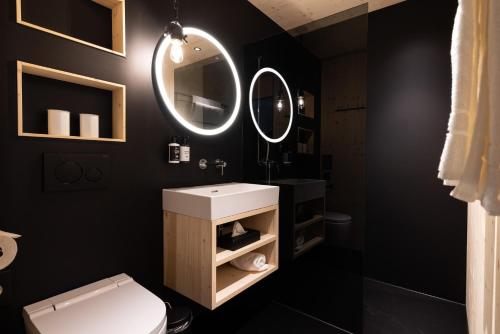 a bathroom with a white sink and a mirror at Bretterhotel in Brienz