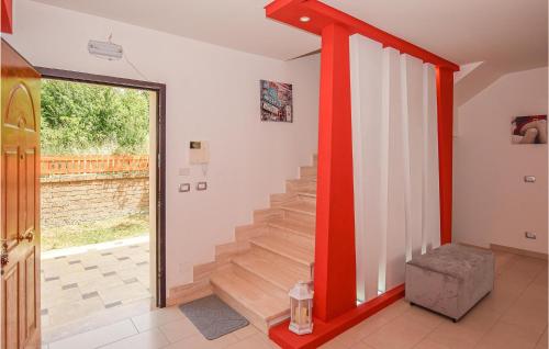 a staircase in a house with a red and white wall at Gorgeous Home In Civitavecchia in Civitavecchia
