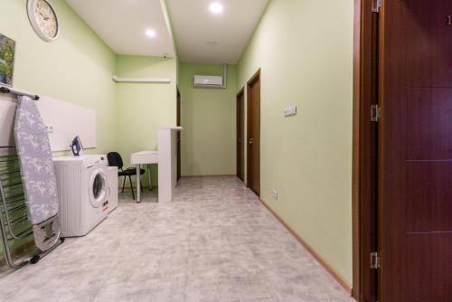 a hallway with a washing machine in a room at HB apartments Laghidze in Tbilisi City