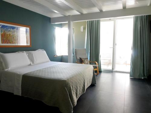 a bedroom with a bed and a large window at Suite Minerva in Polignano a Mare