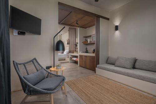 a living room with a couch and a chair at Anmian Suites in Vourvourou