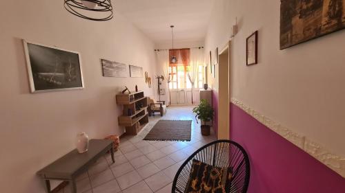 a room with a hallway with a table and chairs at Casa Rosa in Sogliano Cavour