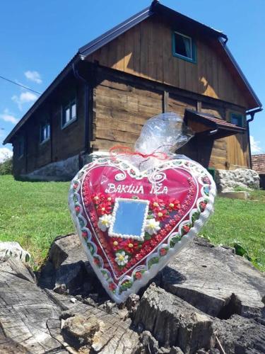 a heart shaped item on a rock in front of a house at Bakina iža in Duga Resa