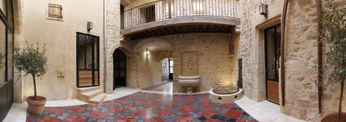a hallway with a tile floor in a building at La Maison d'en Bas des Seigneurs in Cucuron
