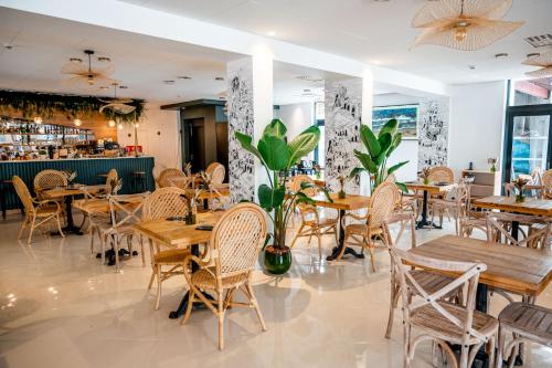 a restaurant with wooden tables and chairs and a bar at AUBERGE KOSKENIA in Bidart