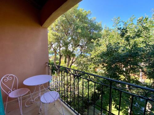 a balcony with a table and chairs and trees at Villa vue mer donnant sur le Golfe de St Tropez, 2 chambres, 6 pers, piscine commune in Saint-Tropez