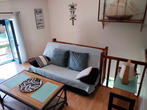 a living room with a couch and a table at La Goélette in Bazincourt-sur-Saulx