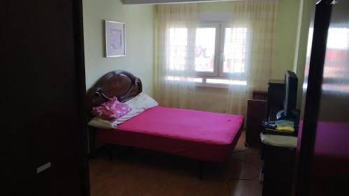 希洪的住宿－habitacion，小房间设有粉红色的长凳和窗户