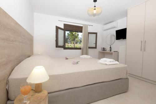 A bed or beds in a room at Seafront Villa Eirini