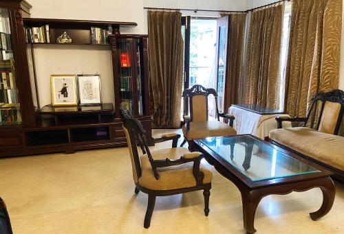 a living room with a couch and a coffee table at The Aster Homestay - Bedrooms & Apartments in Kolkata