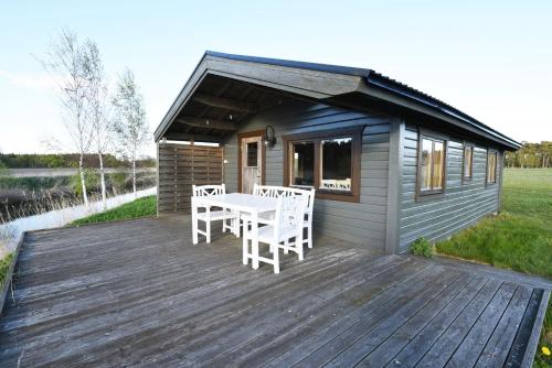 une petite cabine avec une table et des chaises sur une terrasse dans l'établissement Rural cottage on Gotland, à Stånga