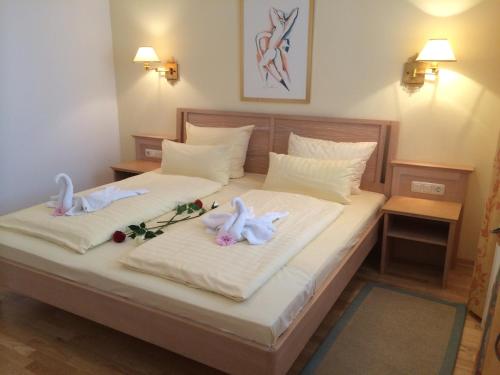 two swans on a bed in a room at Villa Strandblick Binz in Binz