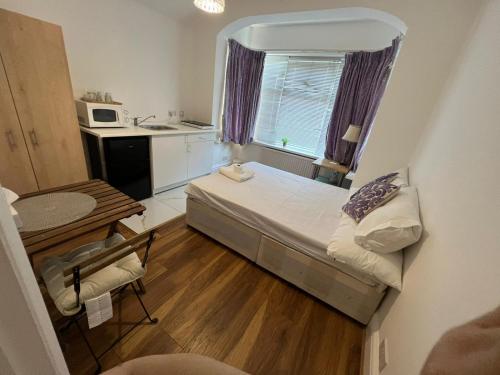 a small room with a bed and a kitchen at Lovely Studio flat in London in London