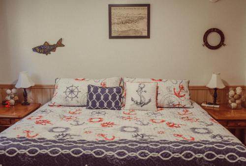 a bed with pillows on it in a bedroom at Pioneer Inn Downtown in Homer
