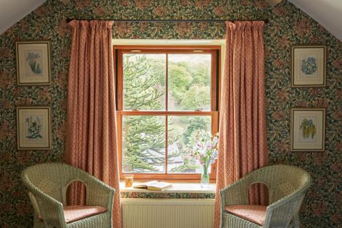 two chairs in front of a window in a room at The Exmoor Forest Inn in Simonsbath
